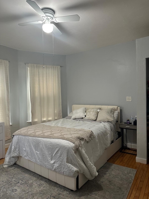 82 Fox Street Worcester, MA 01604 - Photo 20 of 38 a bedroom with a bed and a chandelier