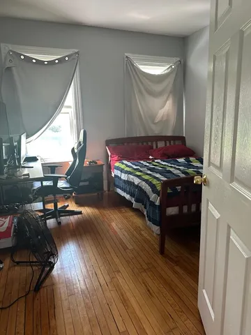 a room with wooden floor and furniture