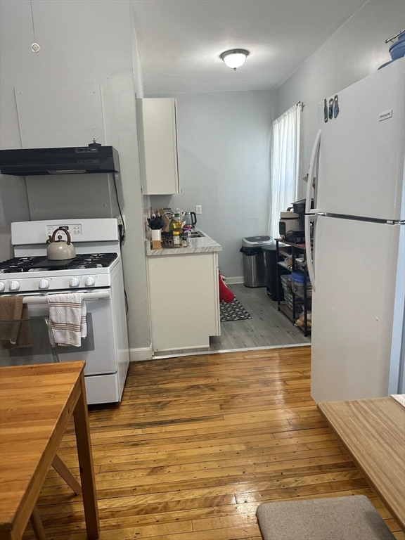 82 Fox Street Worcester, MA 01604 - Photo 25 of 38 a kitchen with a stove and a refrigerator