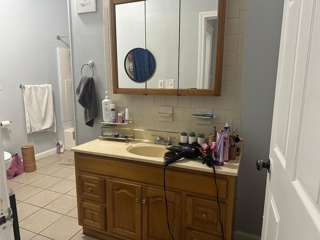 82 Fox Street Worcester, MA 01604 - Photo 27 of 38 a bathroom with a sink and a mirror