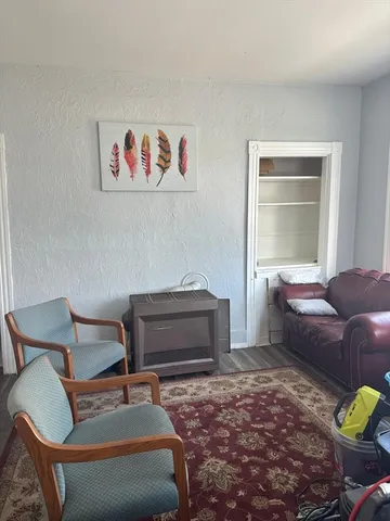 a bedroom with furniture and a window