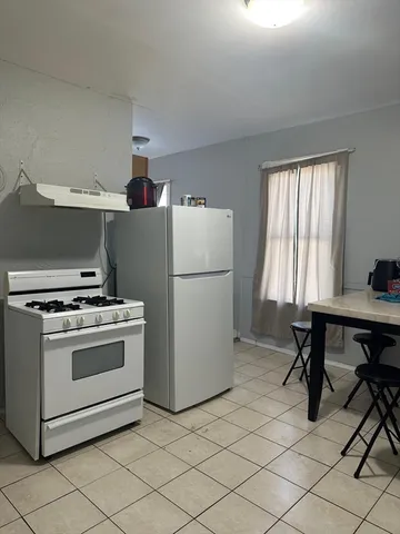 a kitchen with a stove and a refrigerator