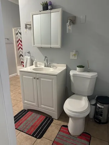 a bathroom with a toilet a sink and a mirror