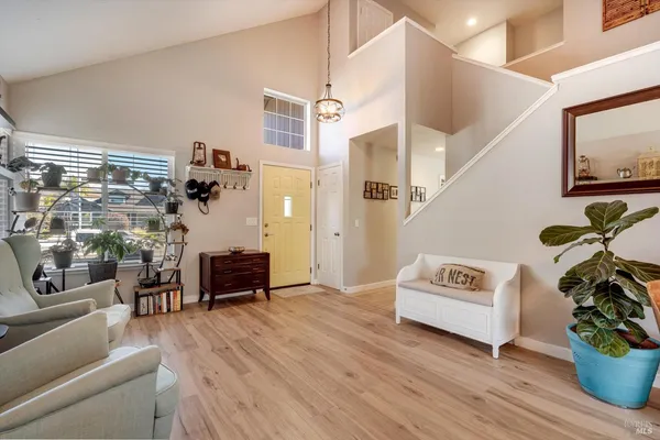 a view of a livingroom with furniture and hardwood floor