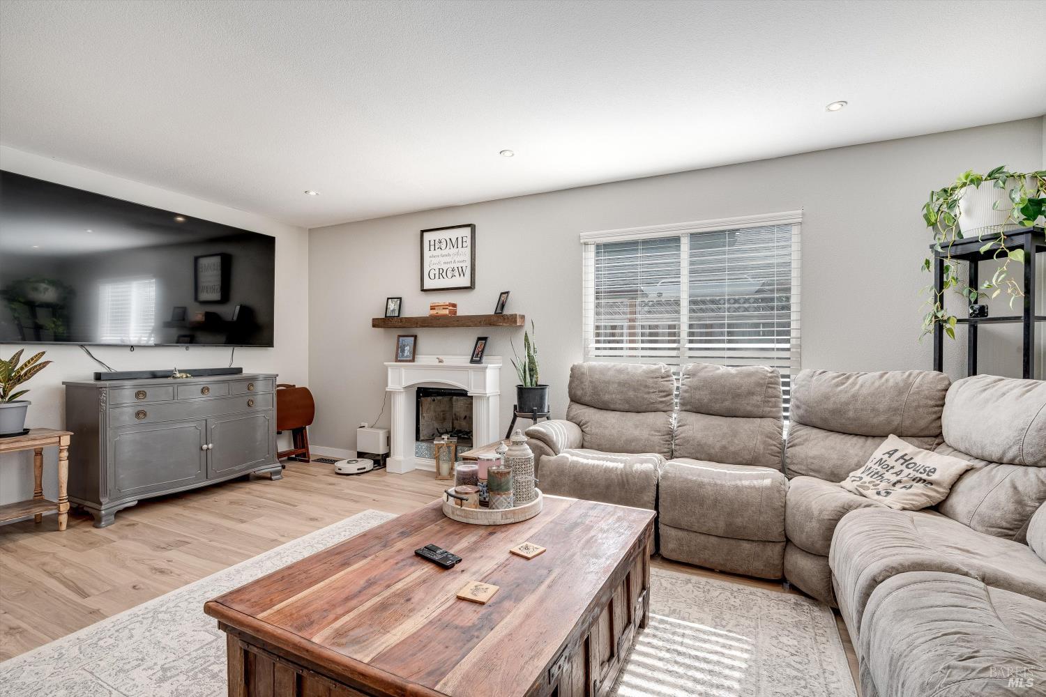 532 Walten Way Windsor, CA 95492 - Photo 23 of 65 a living room with furniture fireplace and a flat screen tv