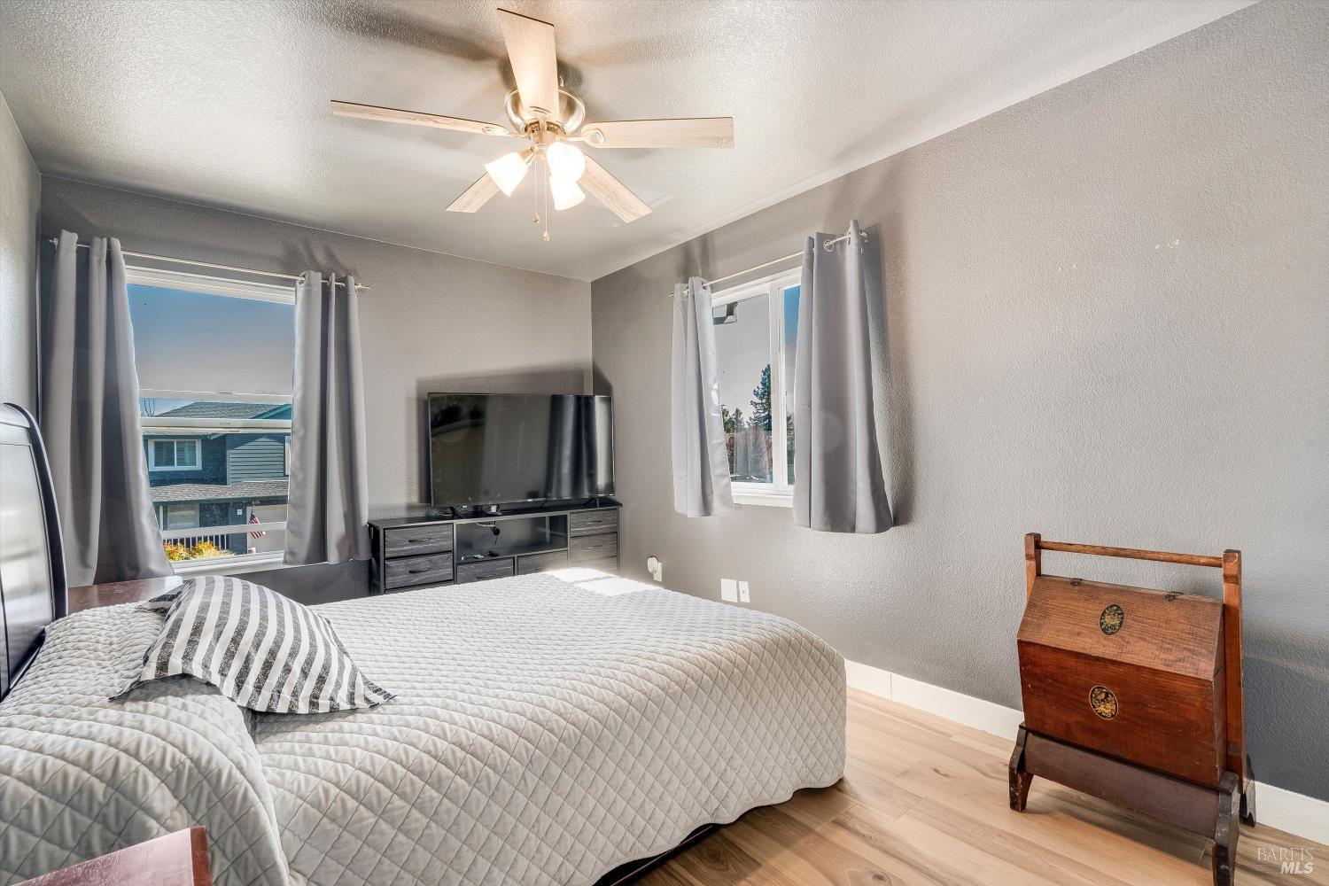 532 Walten Way Windsor, CA 95492 - Photo 44 of 65 a bedroom with a bed and a chandelier