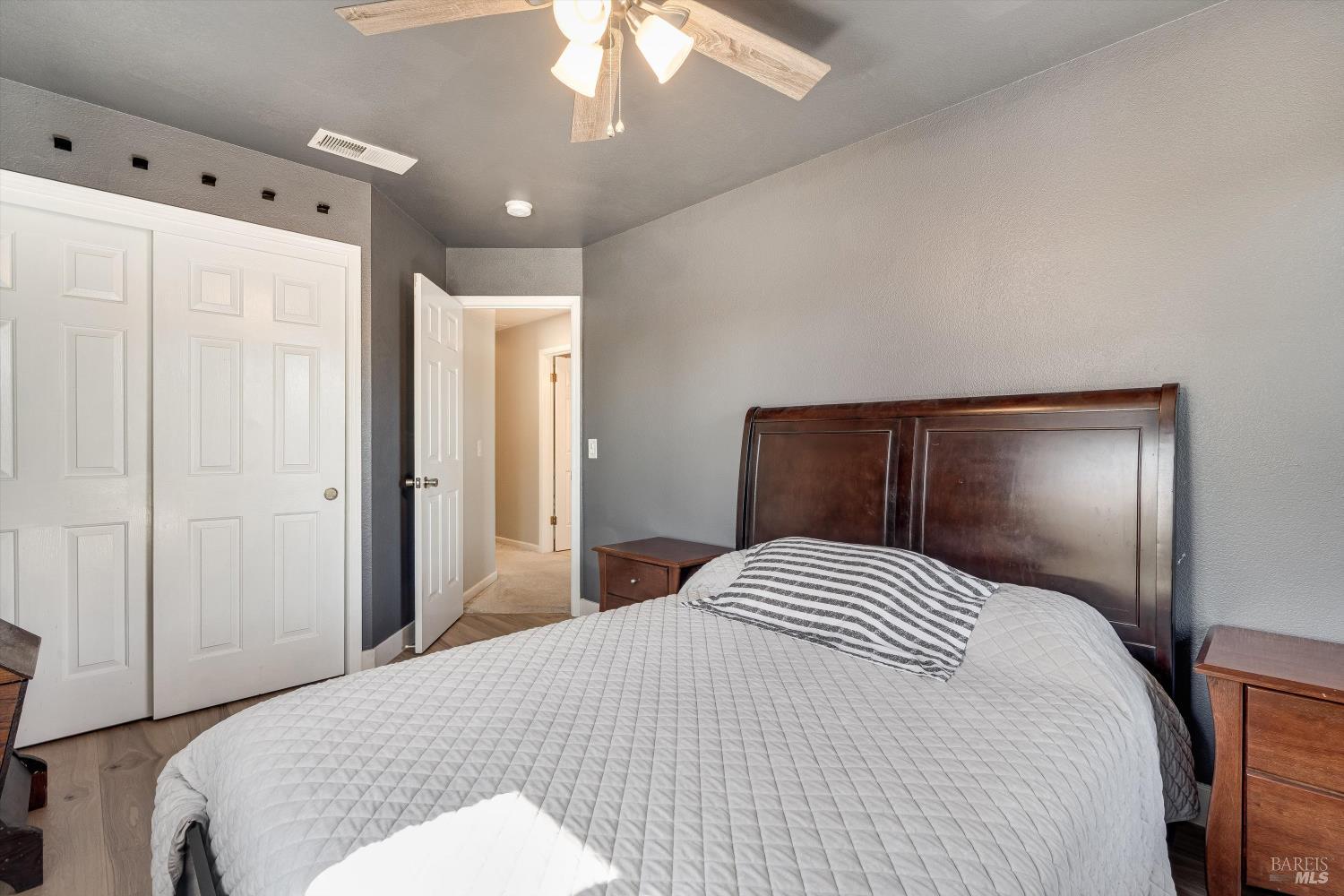 532 Walten Way Windsor, CA 95492 - Photo 45 of 65 a bedroom with a large bed and a chandelier