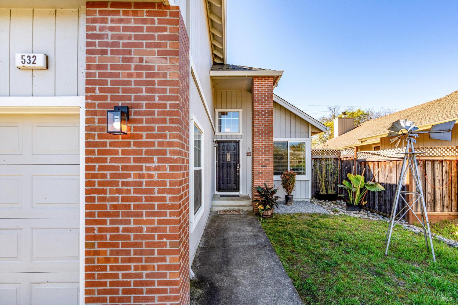 532 Walten Way Windsor, CA 95492 - Photo 8 of 65 a view of a brick house with many windows and a table