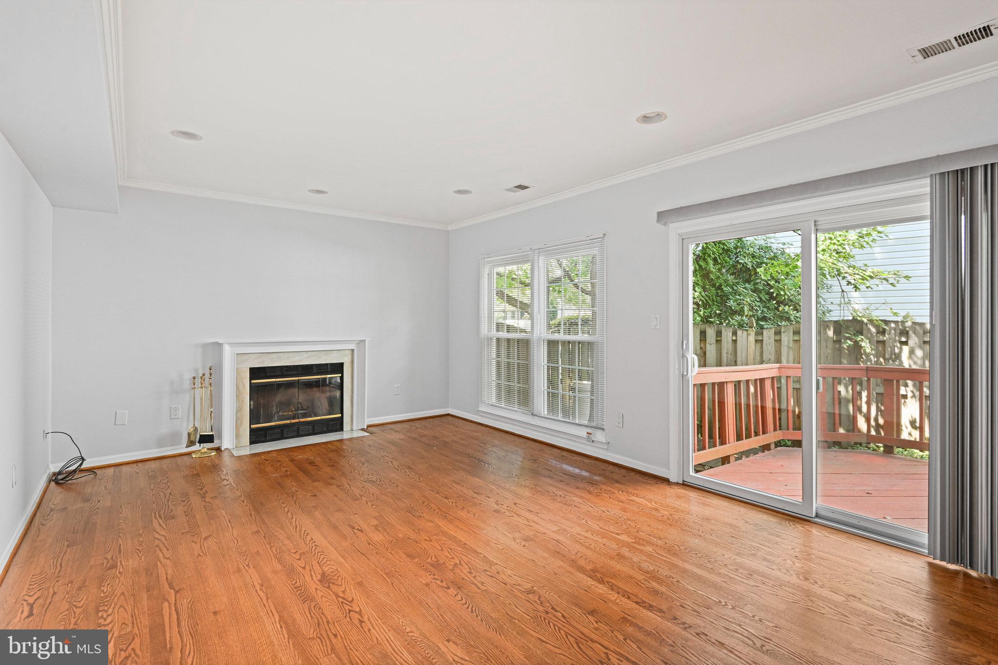 13345 Point Rider Lane Herndon, VA 20171 - Photo 19 of 43 a view of empty room with wooden floor and fireplace