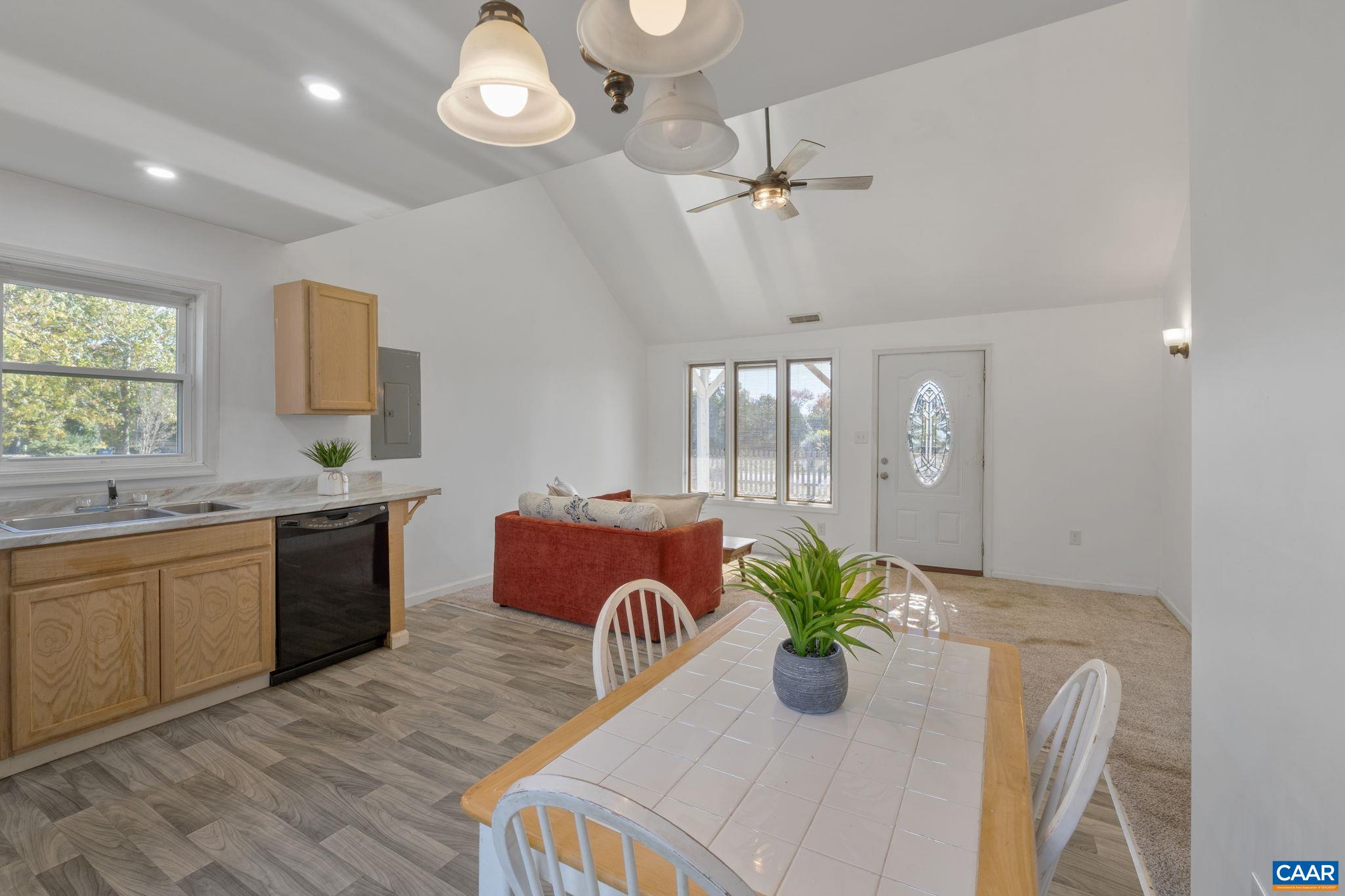 874 James River Road Scottsville, VA 24590 - Photo 12 of 43 a kitchen with stainless steel appliances granite countertop wooden floor a stove a sink a dining table and chairs