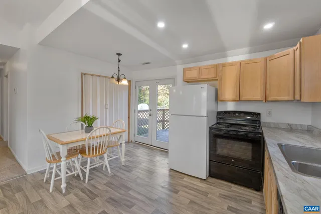 a kitchen with granite countertop white cabinets and stainless steel appliances
