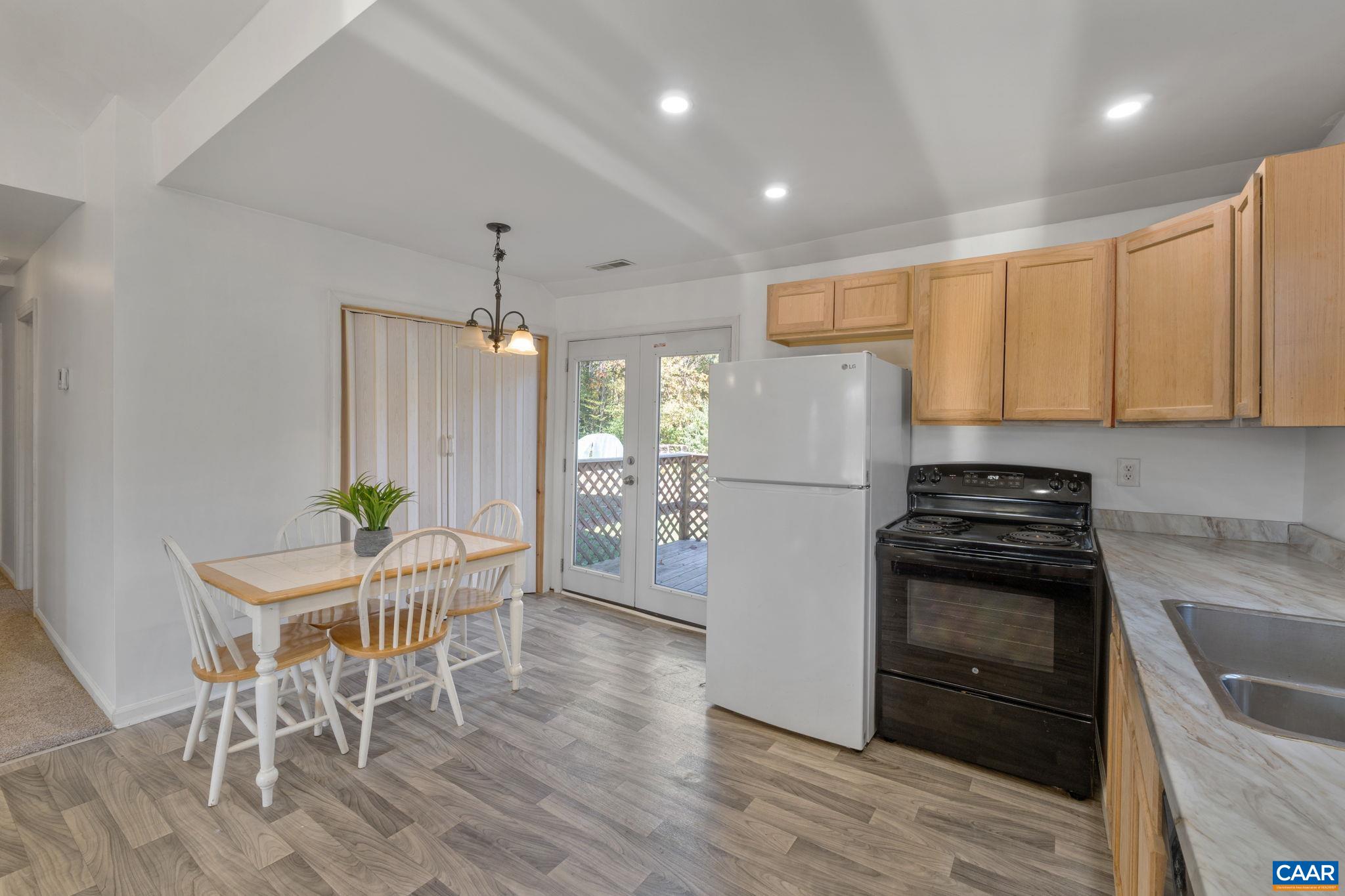 874 James River Road Scottsville, VA 24590 - Photo 13 of 43 a kitchen with granite countertop white cabinets and stainless steel appliances