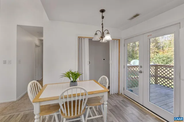a view of a dining room with furniture wooden floor and chandelier