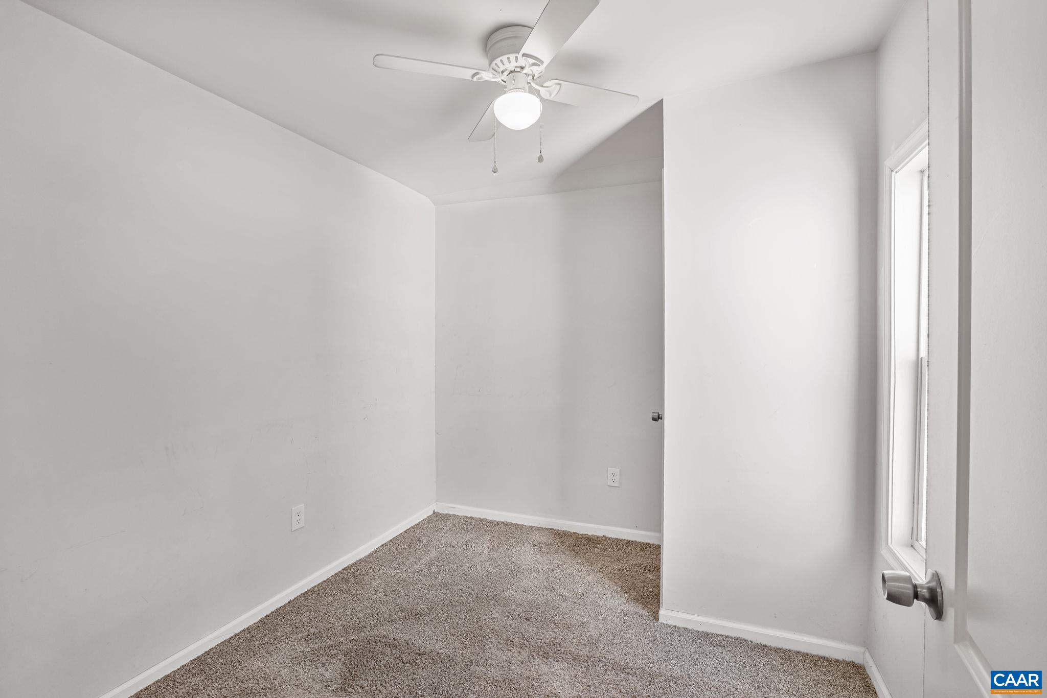 874 James River Road Scottsville, VA 24590 - Photo 16 of 43 an empty room with windows and fan