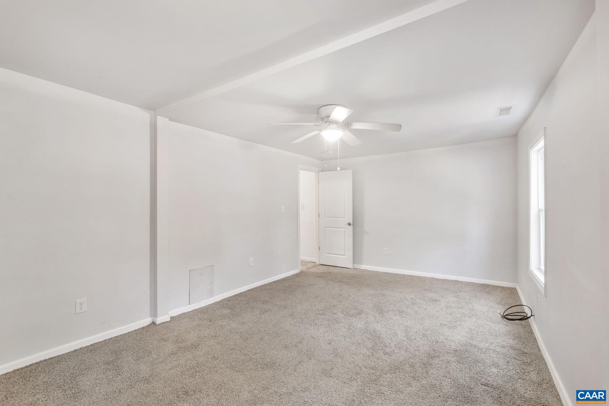 874 James River Road Scottsville, VA 24590 - Photo 20 of 43 a view of an empty room with a chandelier fan