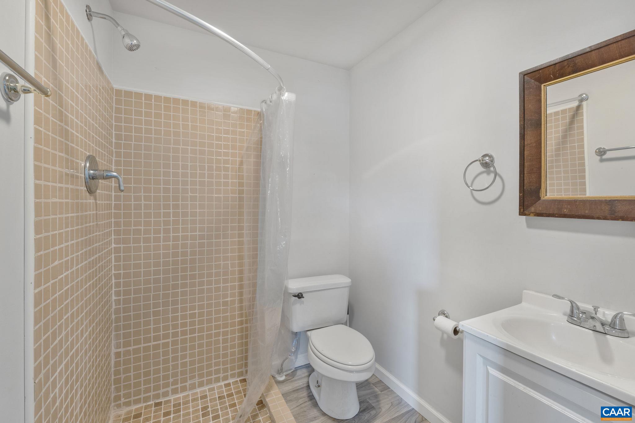 874 James River Road Scottsville, VA 24590 - Photo 22 of 43 a bathroom with a toilet sink vanity and mirror