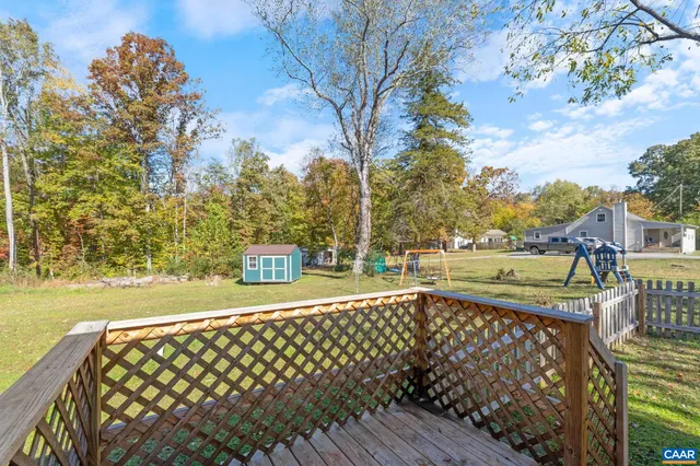 a view of a street with wooden fence