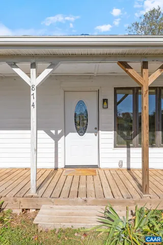 a view of balcony with wooden floor and fence
