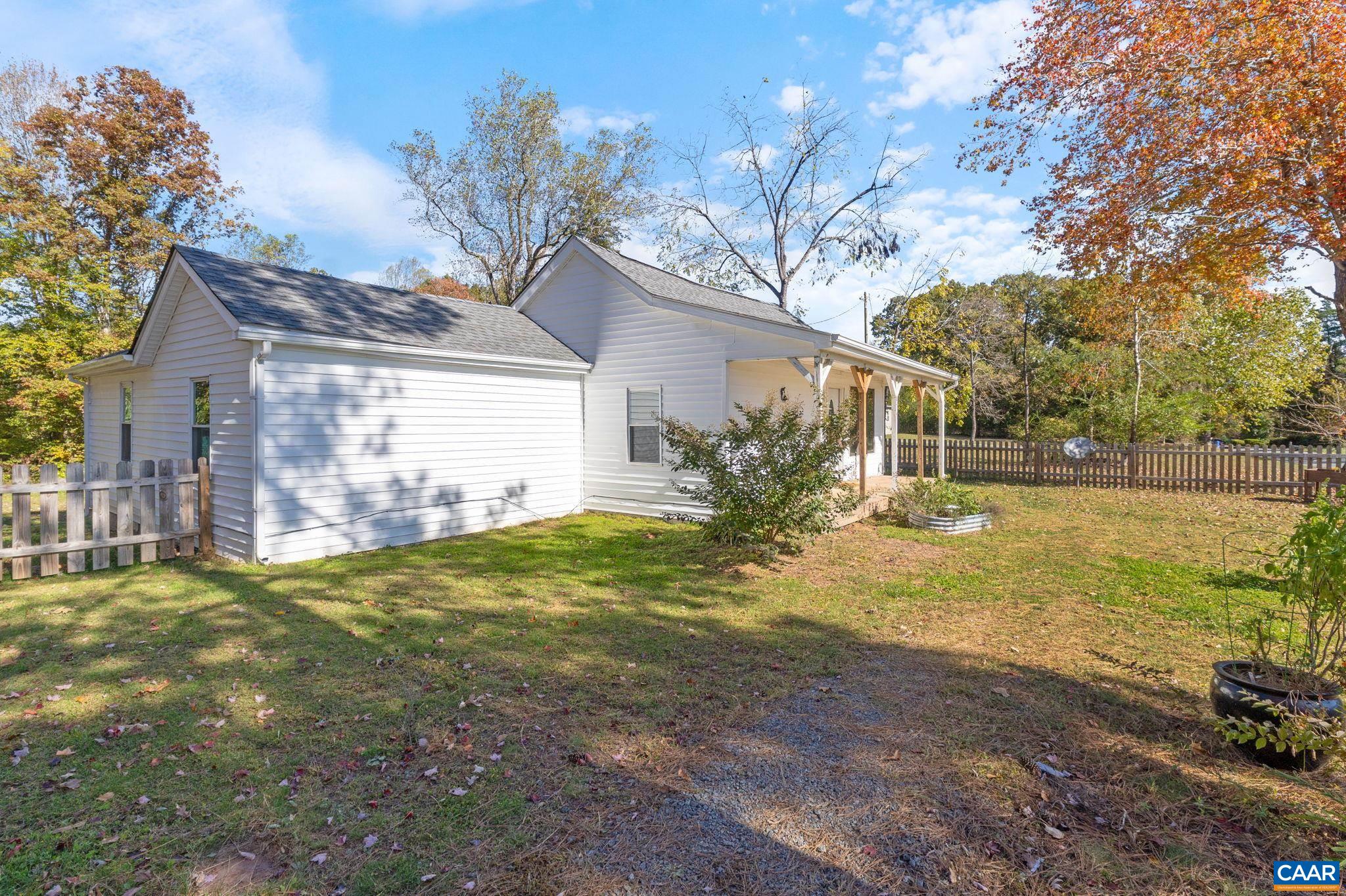 874 James River Road Scottsville, VA 24590 - Photo 3 of 43 a backyard of a house with table and chairs