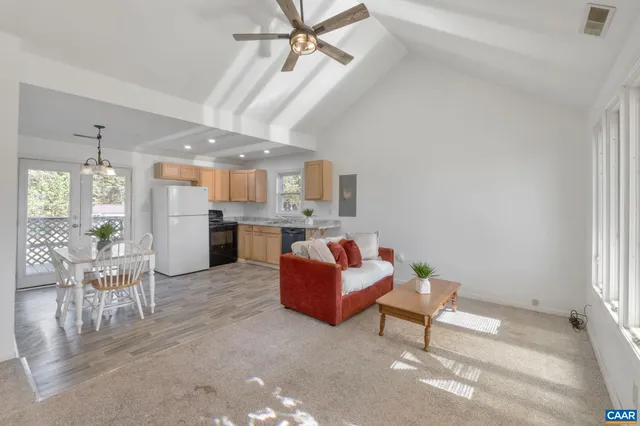 a living room with furniture and a kitchen