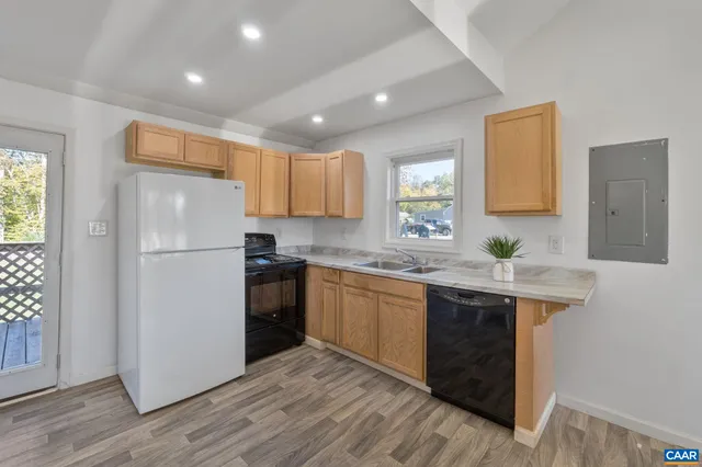 a kitchen with a refrigerator sink and cabinets