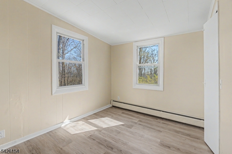 10 Berton Road Boonton, NJ 07005 - Photo 9 of 20 a view of an empty room with a window and wooden floor
