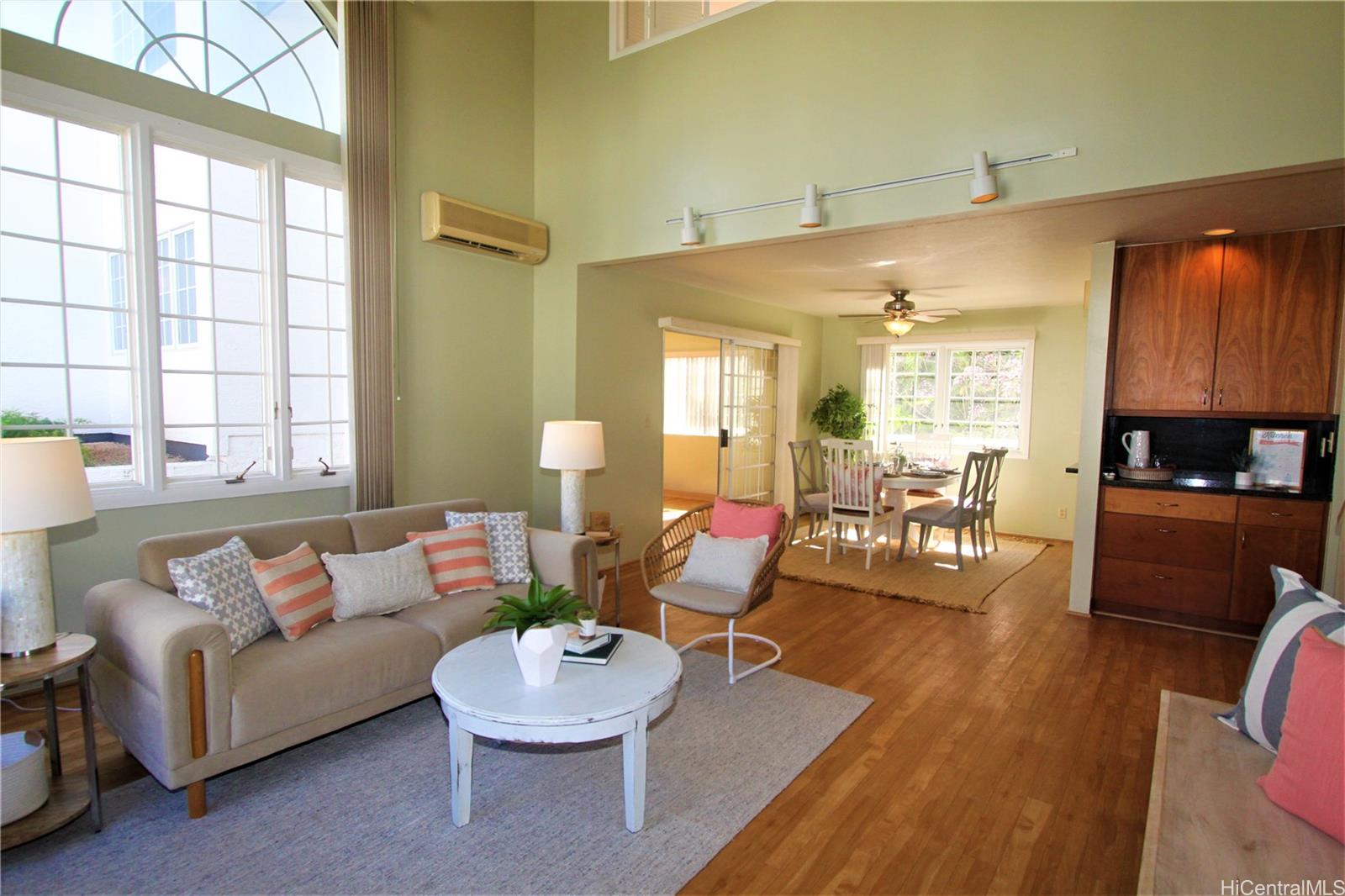 a living room with furniture and a wooden floor