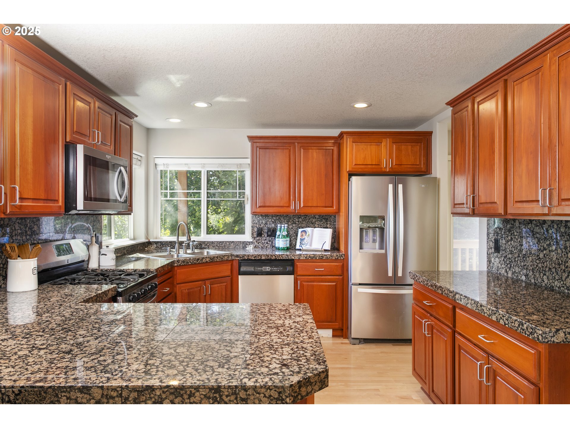 3200 Wild Rose Loop West Linn, OR 97068 - Photo 15 of 47 a kitchen with stainless steel appliances granite countertop a refrigerator sink stove microwave and cabinets