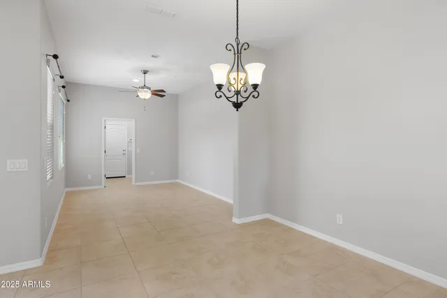 a view of a chandelier in big room and chandelier