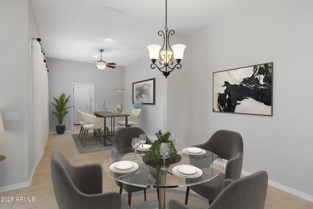 a view of a dining room with furniture and chandelier