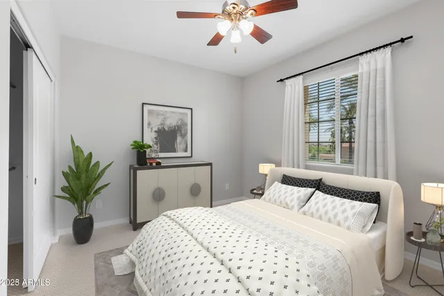 a bedroom with a large bed and a potted plant