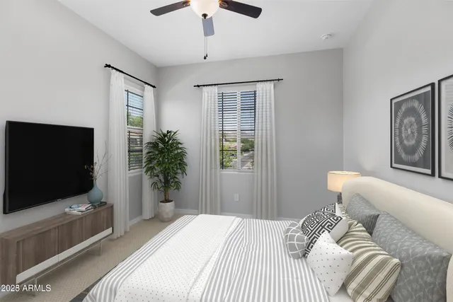 a bedroom with a bed and a flat screen tv