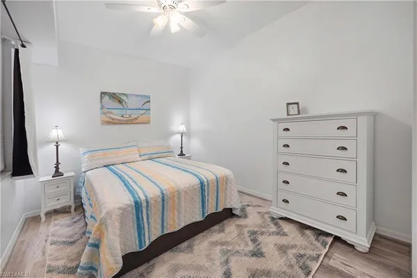 a bedroom with a bed and a night stand