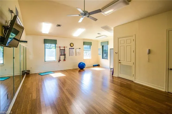 a view of a livingroom with wooden floor and a ceiling fan