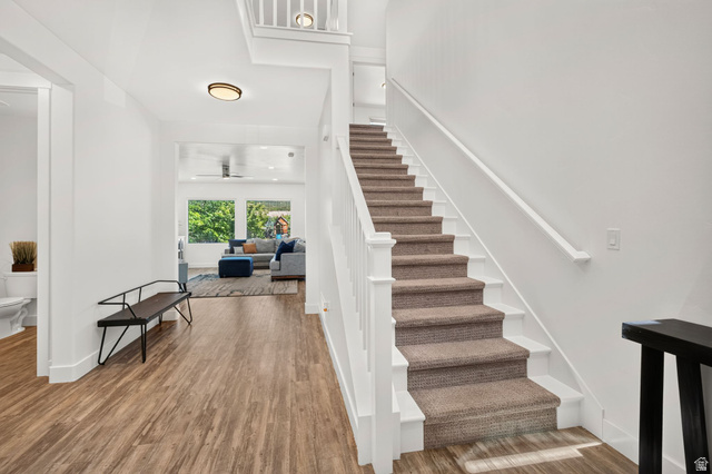 6536 West Muirfield Road Highland, UT 84003 - Photo 13 of 48 Inviting entryway featuring wood-finish flooring and a carpeted staircase with white risers and railing