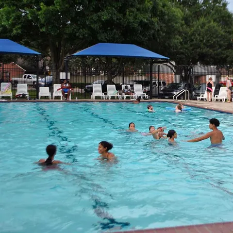 a swimming pool view with a seating space