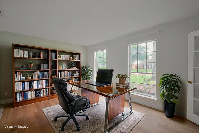 a work room with furniture and a book shelf