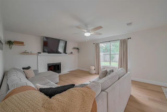 a living room with furniture a fireplace and a flat screen tv