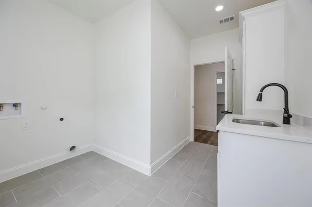 a kitchen with a sink and a mirror