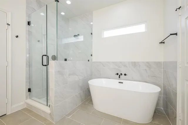 a white bath tub sitting next to a bathroom
