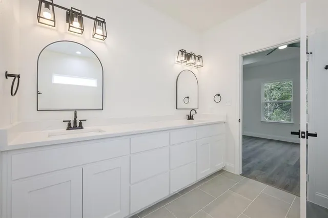 a bathroom with 2 sink and a mirror