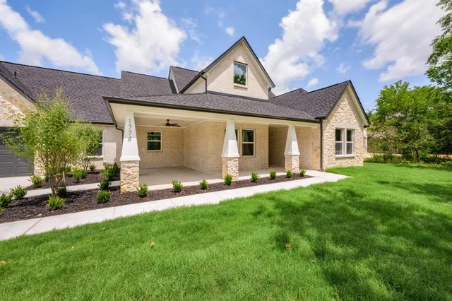 a view of a house with a yard and sitting area