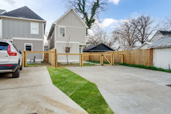 a view of house with outdoor space and parking