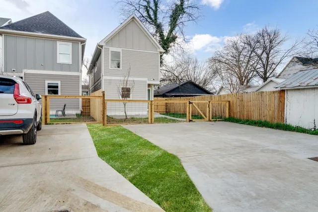 a view of house with outdoor space and parking