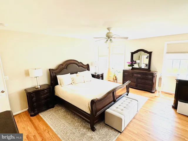 a view of an empty room with kitchen and window