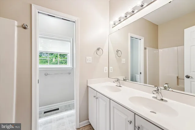 a view of empty room with wooden floor and windows