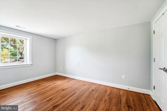 a view of a room with wooden floor