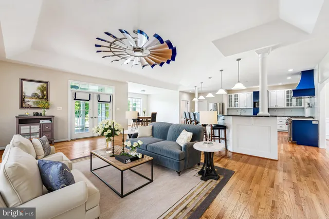 a kitchen with stainless steel appliances granite countertop wooden cabinets a stove top oven a sink and dishwasher a oven with wooden floor