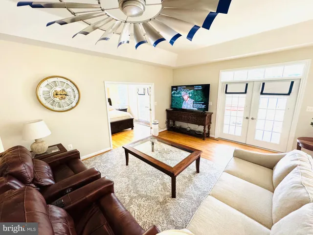 an open kitchen with dining table and wooden floor