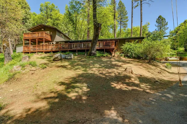 a view of a chair and table in patio with wooden fence